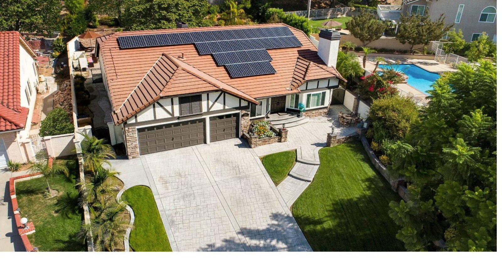 Aerial view of a Raynora-installed residential solar array on a Spanish-revival home